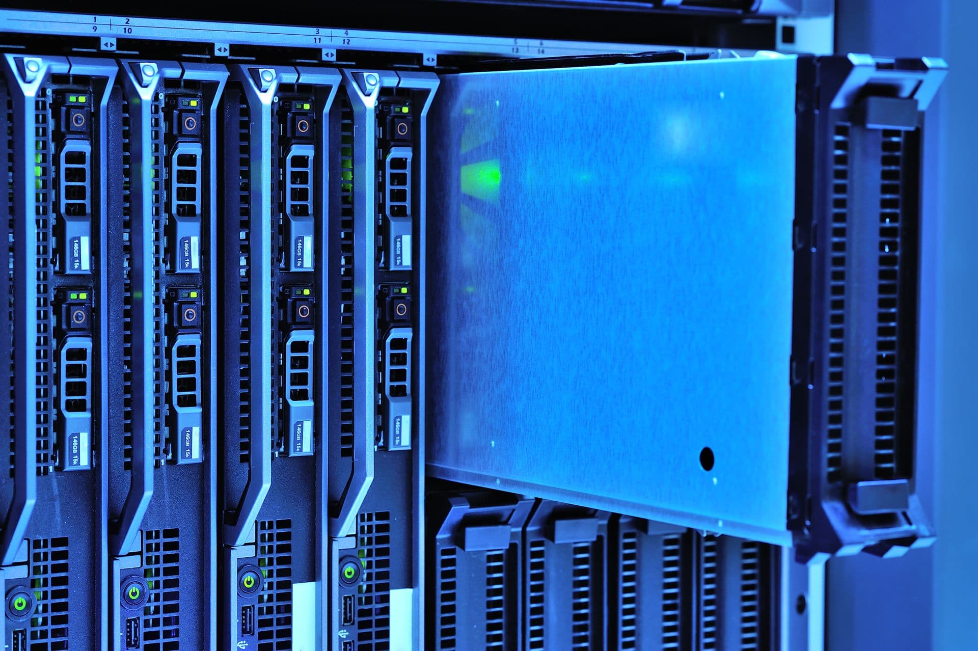 Blue-lit blade servers mounted in a data center enclosure