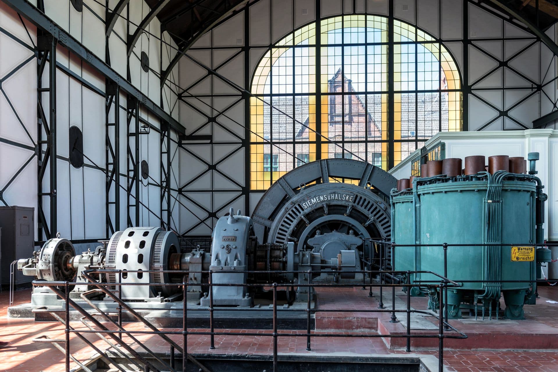 A large rotating electrical generator set inside a power hall