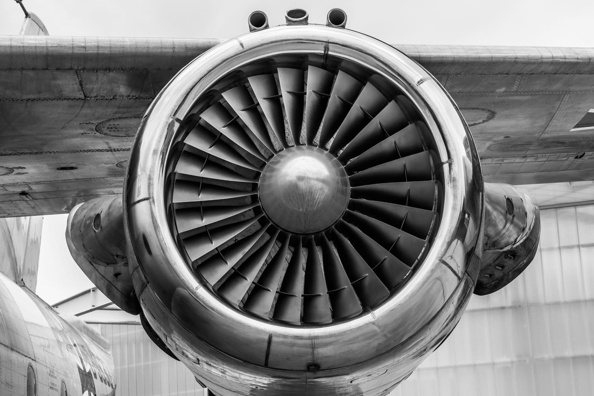 Close-up of a turbine's inlet fan blades and polished nacelle